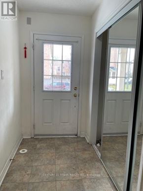 Toronto (Clairlea-Birchmount) townhouse for rent - A white door with a glass window is in a room with a tiled floor.