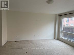 Toronto (Clairlea-Birchmount) townhouse for rent - A room with a window and a carpeted floor.