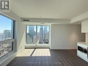 Toronto (Bay Street Corridor) condo for rent - A spacious room with a view of the city skyline.