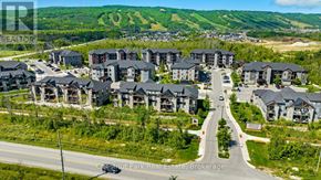 Blue Mountains condo for rent - A bird's eye view of a residential area with houses and a road.
