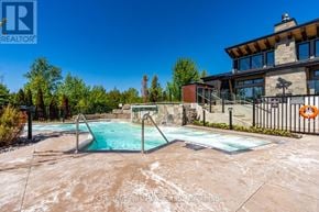 Blue Mountains condo for rent - A swimming pool in a backyard with a house in the background.