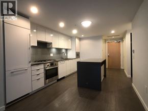 Richmond apartment for rent - A modern kitchen with white cabinets and stainless steel appliances.