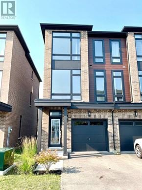 Hamilton (Mcquesten) townhouse for rent - A modern two-story residential building with a garage.