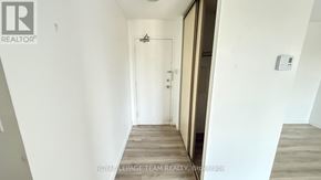 Ottawa condo for rent - A hallway with a door on the right and a wall light on the wall.