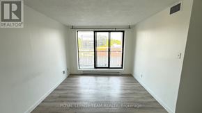 Ottawa condo for rent - A room with a sliding glass door leading to a balcony.