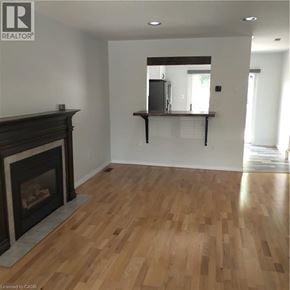 Guelph apartment for rent - A living room with a fireplace and a mirror on the wall.