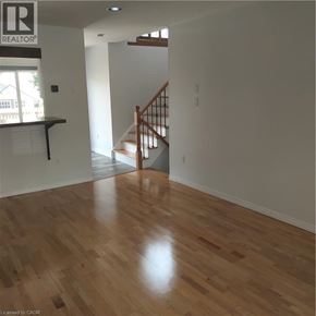 Guelph apartment for rent - A room with wooden flooring and a staircase.