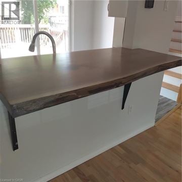 Guelph apartment for rent - A kitchen counter with a dark brown top and black legs.