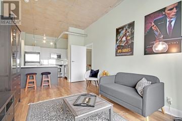 Toronto (Waterfront Communities) condo for rent - A living room with a grey couch and a coffee table in front of a wall with posters.