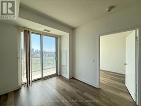 Toronto (Kensington-Chinatown) condo for rent - A room with a sliding glass door leading to a balcony.