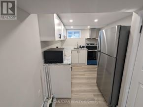 Hamilton (Hill Park) apartment for rent - A kitchen with a refrigerator, microwave, and oven.