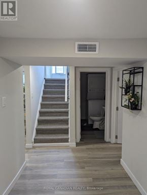 Hamilton (Hill Park) apartment for rent - A hallway with a staircase leading to a bathroom.