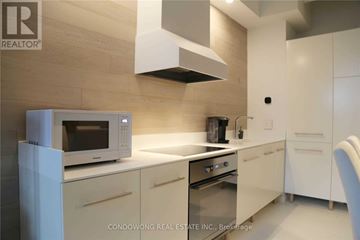 Toronto (Church-Yonge Corridor) condo for rent - A modern kitchen with white cabinets and a microwave.