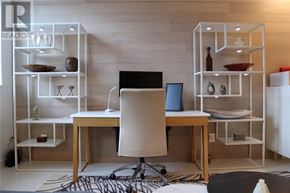 Toronto (Church-Yonge Corridor) condo for rent - A modern home office with a wooden desk and white shelving units.