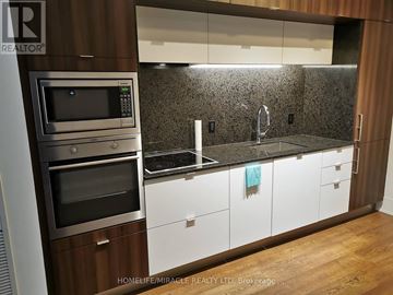 Toronto (Waterfront Communities) condo for rent - A modern kitchen with a stainless steel oven and microwave.
