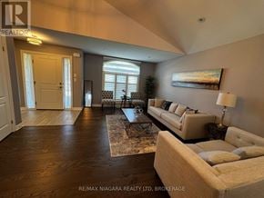 Niagara Falls (Oldfield) apartment for rent - A living room with a couch, coffee table, and a painting on the wall.