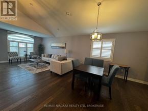 Niagara Falls (Oldfield) apartment for rent - A well-lit living room with a dining table and chairs.