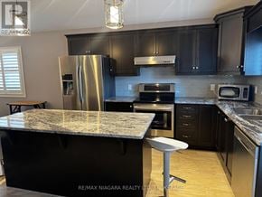 Niagara Falls (Oldfield) apartment for rent - A kitchen with a granite countertop and stainless steel appliances.