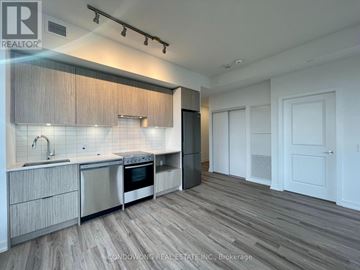 Toronto (Cabbagetown-South St. James Town) condo for rent - A modern kitchen with wooden cabinets and stainless steel appliances.