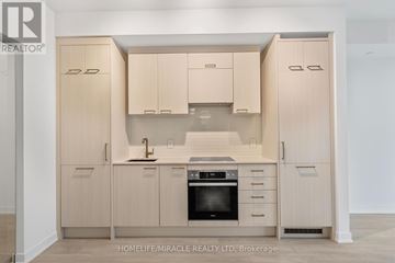 Toronto (Church-Yonge Corridor) condo for rent - A kitchen with wooden cabinets and appliances.