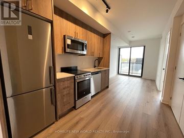 Toronto (Dovercourt-Wallace Emerson-Junction) condo for rent - A kitchen with wooden cabinets and stainless steel appliances.