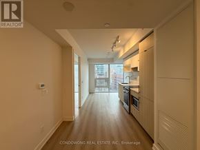 Toronto (Church-Yonge Corridor) condo for rent - A spacious kitchen with wooden floors and a view of the city.