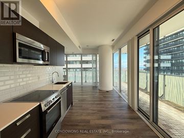Toronto (Church-Yonge Corridor) condo for rent - A modern kitchen with dark brown cabinets and stainless steel appliances.