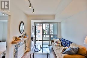 Toronto (Kensington-Chinatown) condo for rent - A living room with a couch, a coffee table, and a fireplace.