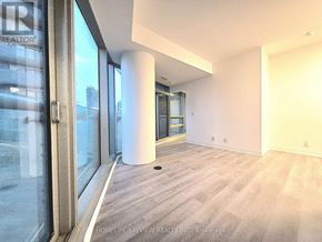 Toronto (Waterfront Communities) condo for rent - A room with a large window and a sliding glass door.