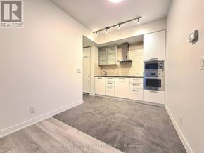 Toronto (Waterfront Communities) condo for rent - A kitchen with white cabinets and a tile backsplash.