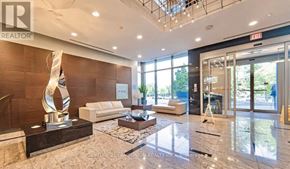 Toronto (Agincourt South-Malvern West) condo for rent - A modern office lobby with a marble floor and a sculpture on a pedestal.