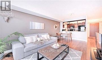 Toronto (Agincourt South-Malvern West) condo for rent - A living room with a grey couch and a glass coffee table.