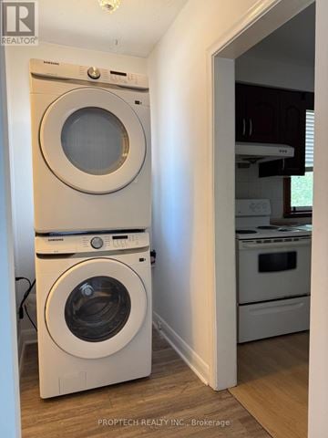 Richmond Hill (Crosby) apartment for rent - A white front load washing machine and dryer in a laundry room.
