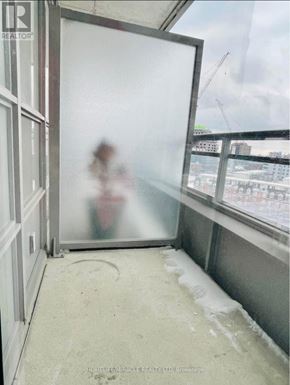 Toronto (South Parkdale) condo for rent - A person is standing in a doorway with a blurred reflection.