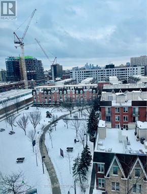 Toronto (South Parkdale) condo for rent - A snowy cityscape with apartment buildings and construction cranes.