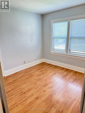 Hamilton (Stoney Creek) triplex for rent - A room with a window and wooden flooring.