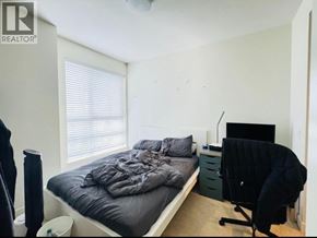 Vancouver apartment for rent - A bedroom with a bed, desk, and chair.