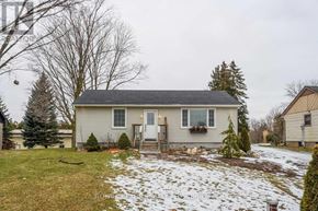 Hamilton (Waterdown) apartment for rent - A house with a grey roof and a white door is surrounded by a snowy landscape.