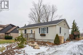 Hamilton (Waterdown) apartment for rent - A house with a grey roof and a small front yard.
