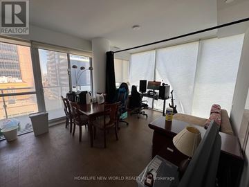 Toronto (Bay Street Corridor) condo for rent - A living room with a dining table and chairs, a sofa, and a television.