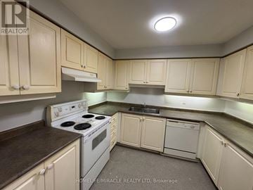 Toronto (Kennedy Park) townhouse for rent - A kitchen with white cabinets and a stove top oven.