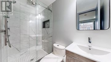 Brampton (Northgate) multi-family for rent - A white bathroom with a marble tile shower.