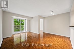 Toronto (Lawrence Park South) condo for rent - A room with wooden flooring and a sliding glass door leading to a balcony.