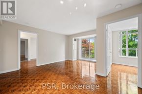 Toronto (Lawrence Park South) condo for rent - A room with wooden flooring and white walls, with a window showing greenery outside.