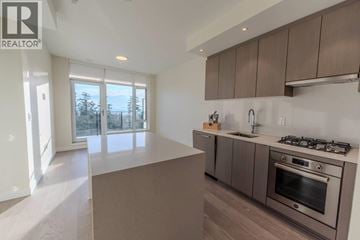 Vancouver apartment for rent - A modern kitchen with a stainless steel oven and a large island.