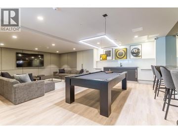 Coquitlam apartment for rent - A modern living room with a pool table and a television.