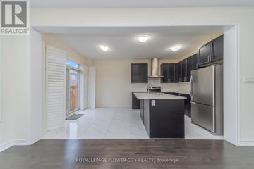 Brampton (Northwest Brampton) apartment for rent - A kitchen with black cabinets and a stainless steel refrigerator.
