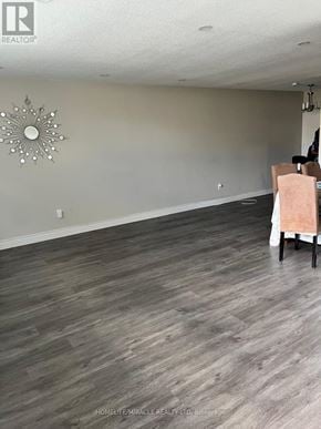 Hamilton (Vincent) condo for rent - A room with wooden flooring and a wall mirror.