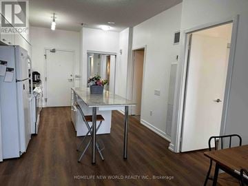 Toronto (Bayview Village) condo for rent - A kitchen with a table and chairs in the middle of the room.