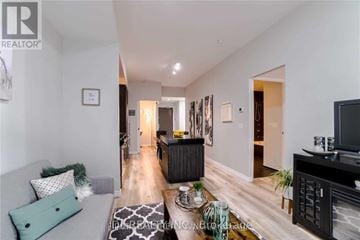 Toronto (Church-Yonge Corridor) condo for rent - A living room with a grey couch and a black cabinet.